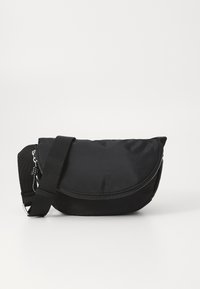 Black crossbody bag made of nylon, featuring a curved design, zipper closure, adjustable strap, and minimalist look.