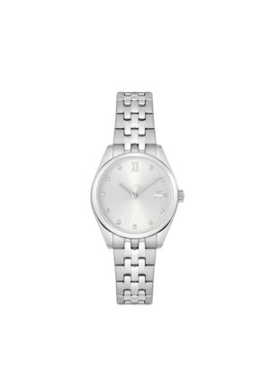 Montre en argent avec un cadran rond, un design minimaliste, des index horaires en petits gemmes et un bracelet en acier inoxydable à maillons.