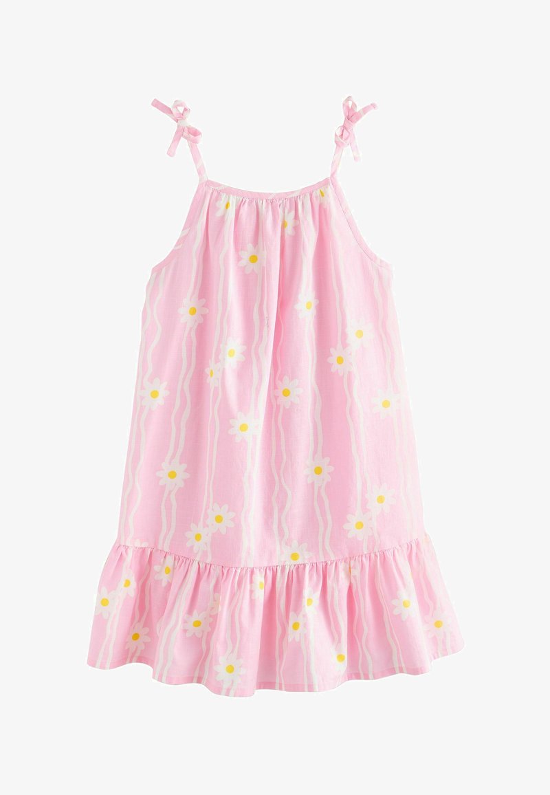 Robe rose sans manches avec motif de marguerites blanches et jaunes, ourlet volanté et bretelles ajustables à nouer sur un fond blanc uni.