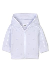 Svetlo modra zip-up kapuca iz teksturirane tkanine, z diskretnim vzorcem logotipa po celotni površini, elastičnimi manšetami in veliko kapuco.