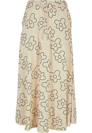 Beige rok met een losse pasvorm, voorzien van een zwart bloemenpatroon en een elastische tailleband met een trekkoord voor aanpassing.