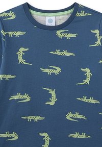 Blue cotton t-shirt featuring a repeated pattern of green alligators in various poses, round neck, smooth texture, and contrasting inner collar.
