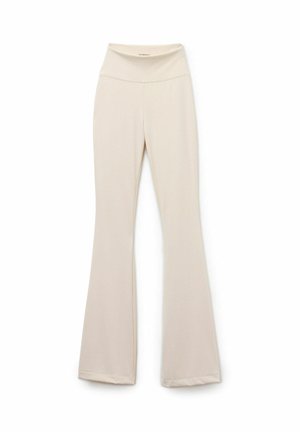Beige flared leggings gemaakt van glad, rekbaar materiaal met een hoge tailleband. Bevat subtiele stiksels en een schoon, minimalistisch ontwerp.