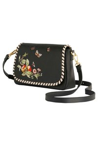 Sac à bandoulière en cuir noir avec des papillons brodés et des motifs floraux, bord crème et fermeture en matériel doré.