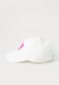 White cotton baseball cap featuring pink embroidered text on the front, curved brim, and an adjustable strap at the back.