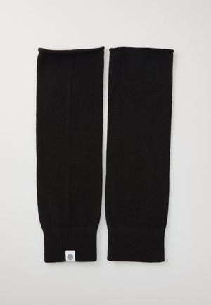 Black knit arm warmers with ribbed cuffs, featuring a smooth texture and a small white tag with a fingerprint design at the bottom.