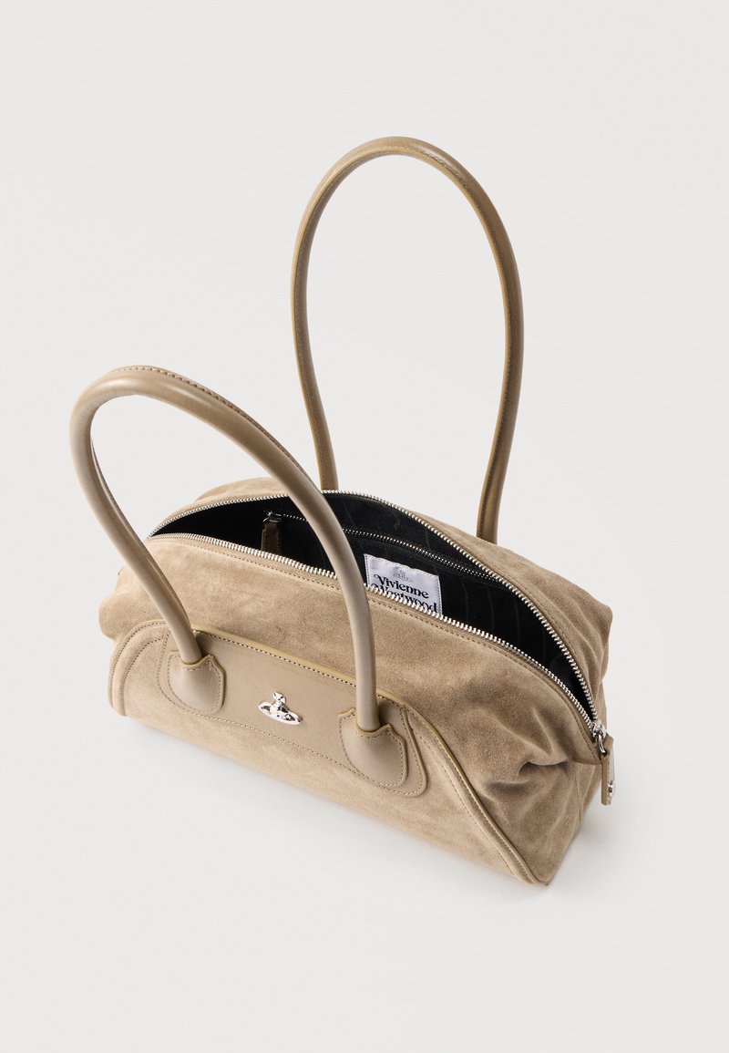 Beige suede handbag with two handles, partially open zipper revealing black interior and white designer label inside.