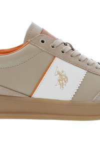 Beige sneakers med slät läder och mockadetaljer, vit sidopanel med orange accent, har en ljusbrun sula och logodesign.