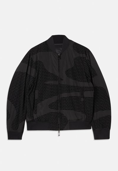 Black bomber jacket with zip closure, featuring a textured pattern of repeating text. Ribbed cuffs and hem, smooth fabric finish.