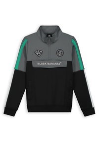 Pulloverjacka gjord av mjukt tyg, med en grå överdel, svart underdel, gröna sidodetaljer och broderade logotyper på bröstet.