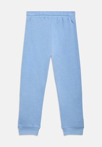 Φωτεινό γαλάζιο παντελόνι φόρμας από απαλό υλικό, με ελαστική μέση και ελαστικά τελειώματα στους αστραγάλους. Απλός, λιτός σχεδιασμός.