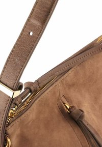 Borsa a mano in pelle marrone con un esterno liscio, zip dorata e un design strutturato, dotata di una tracolla regolabile e removibile.