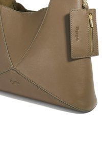 Brown leather handbag with a triangular design, featuring contrasting stitching, gold hardware, and a detachable zippered pouch.