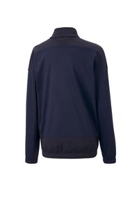 Laivasilakkinen polyesteritakki, jossa on korkea kaulus, pitkät hihat ja joustavat hihansuut. Takissa on sileä pinta ja kontrastiväri olkapäissä.