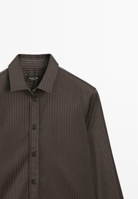 Camicia marrone scuro con bottoni, presenta un delicato motivo a righe verticali, maniche lunghe e un colletto classico. Tessuto di qualità con texture liscia.