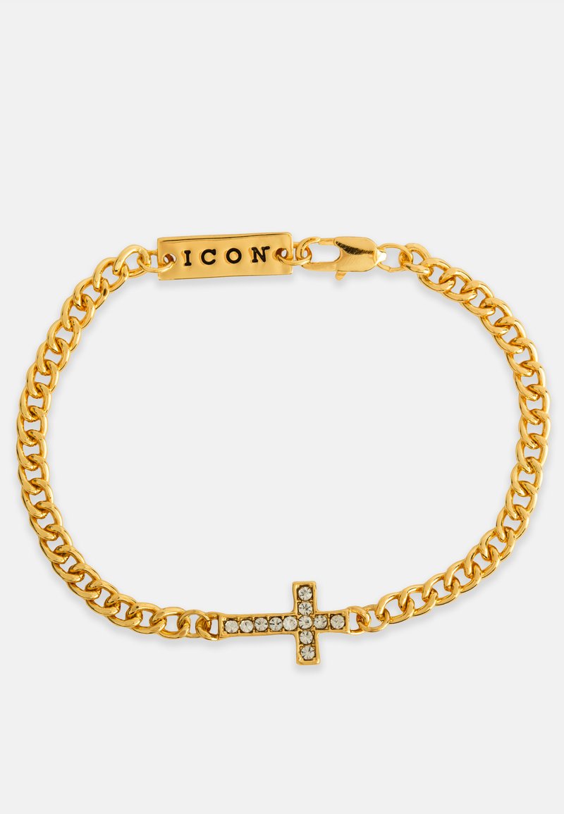 Brățară din lanț de aur cu un accent central în formă de cruce, decorată cu pietre clare și un eticheta gravată cu textul "ICON". Cercei cu linkuri texturate.