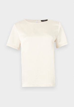 Haut à manches courtes de couleur crème avec un col rond, une texture lisse et une fermeture au dos avec un trou en forme de goutte. Design classique et minimaliste.