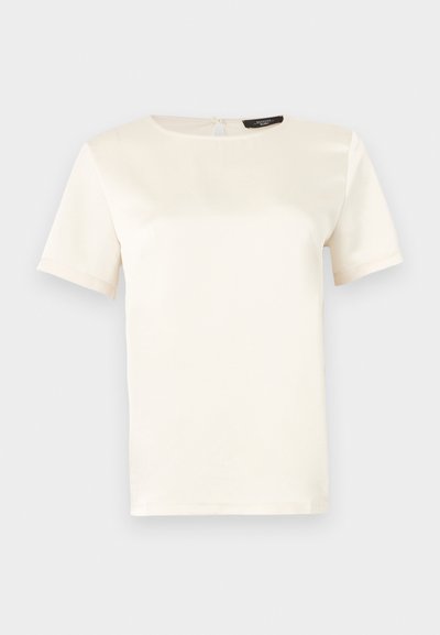 Μπλούζα με κοντά μανίκια σε εκρού χρώμα, με στρογγυλή λαιμόκοψη, λεία υφή και κλείσιμο στην πλάτη με άνοιγμα. Κλασικός και μινιμαλιστικός σχεδιασμός.
