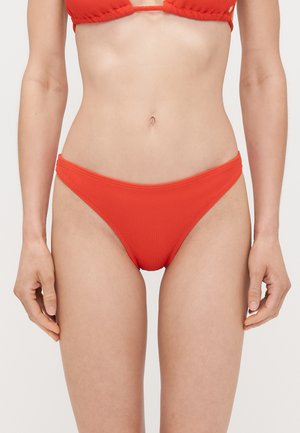Red ribbed bikini bottoms with a low-rise design. Smooth texture and minimal coverage. Seams are neatly finished along the edges.