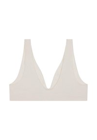 Krämfärgad ribbade bralette med djup V-ringning och breda axelband. Tillverkad av mjukt material, med en sömlös design och en minimalistisk form.