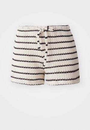 Knit shorts in cream with black stripes. Features a drawstring waistband and textured fabric. Short length, casual design.