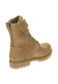 Botas de cuero marrón con forro de pelo sintético, suela de goma y diseño de cordones. Presenta un logo estampado en el costado y detalles de construcción robustos.