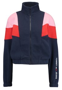 Fleece bunda s vysokým límcem, v barvách růžové, červené a námořnické modré s barevnými bloky. Zapínání na zip a elastické manžety. Název značky na rukávu.