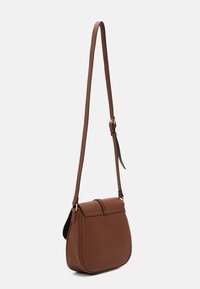 Sac bandoulière en cuir marron avec une forme semi-structurée, une longue sangle réglable et une fermeture à rabat plié. Surface texturée avec des lignes épurées.