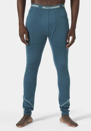 Blauwe thermoleggings met een smalle pasvorm, gemaakt van gestructureerde stof. Voorzien van een contrasterende elastische tailleband met de opdruk "HELLY HANSEN".