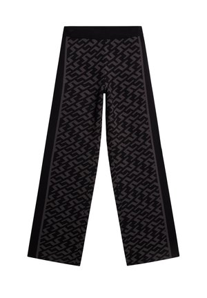 Pantalons à jambes larges en noir et gris, arborant un motif zigzag avec une finition texturée. Taille élastique et panneaux latéraux contrastants.