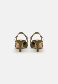 Green suede high-heeled sandals with a back strap and a small heel. Features a smooth finish and a rounded toe design.