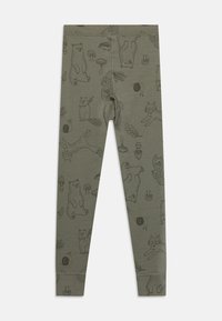 Green leggings made of soft fabric, featuring a repeated pattern of animals and nature motifs in darker shades. Smooth texture, elastic waistband.