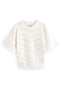 Bílý krajkový crop top s krátkými rukávy, se geometrickým vzorem a ribovaným výstřihem a lemem. Lehká a poloprůsvitná textura.