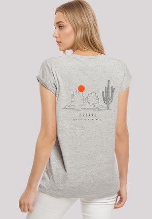 Gray short-sleeve T-shirt featuring a black line art design of a desert scene with a cactus and sun. Soft texture and relaxed fit.