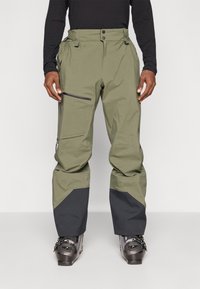 Pantaloni de zăpadă impermeabili, verzi, cu un panou inferior negru, buzunar lateral cu fermoar, talie ajustabilă și mansete întărite pentru durabilitate.