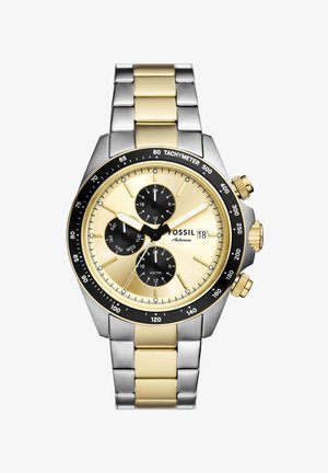 Zweifarbige gold- und silberne Fossil-Armbanduhr mit Tachymeter-Lünette, drei schwarzen Hilfszifferblättern, die Tag, Zeit und Dualzeit anzeigen, sowie Datumsanzeige.