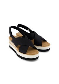 Sandalias de tela negra con correas entrelazadas, plantilla de ante y suela de plataforma en blanco y negro. Diseño ajustable de talón para un mejor ajuste.
