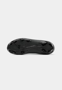Black soccer cleat sole features a smooth texture with six round studs and a sleek design, accented by a subtle pattern running along the surface.