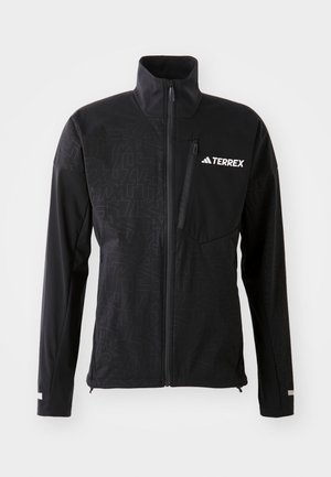 Schwarze Terrex-Jacke mit hohem Kragen, Reißverschluss vorne und dezenten geometrischen Mustern. Verfügt über ein weißes Logo und eine Reißverschlusstasche auf der Brust.