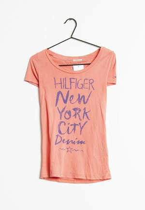 T-shirt corto corallo con maniche corte e scollatura rotonda. Presenta testo viola "HILFIGER NEW YORK CITY Denim" e una grafica di una stella.