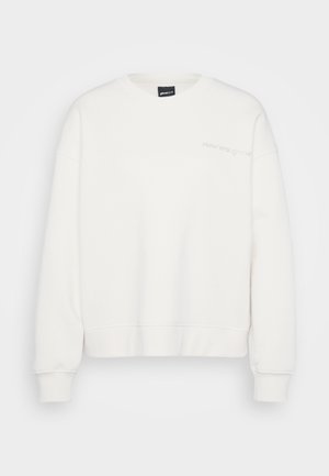 Biała bluza, mieszanka bawełny, dekolt okrągły, oversize, ściągacze na rękawach i dole, subtelne hafty w jasnym kolorze na piersi.