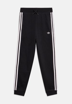 Pantalon de survêtement Adidas noir avec bandes blanches latérales, taille élastique avec cordon, poignets aux chevilles et petit logo blanc Adidas sur la cuisse gauche.