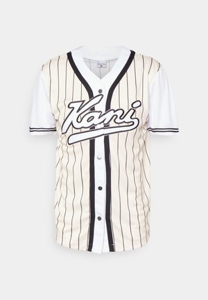 Kortærmet beige og hvid baseballtrøje med sorte lodrette striber, knapper med tryk og "Kani"-logo på brystet.
