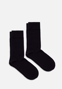 Svarta bomullssockor med en slät textur, utrustade med en ribbadkant och förstärkt tå. Designade för komfort och hållbarhet.