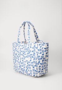 Canvas tote bag featuring a blue and white geometric pattern, with two sturdy handles and a spacious design.