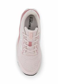 Light pink athletic sneaker with textured mesh upper, white accents, and pink laces. Features a rounded toe and padded collar for comfort.
