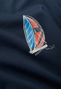 Tela en color navy con un gráfico estilizado de velero en azul y rojo. El velero presenta detalles de líneas intrincadas y una firma en la base.