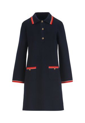 Temno modra obleka z dolgimi rokavi, z rdečimi in belimi obrobami na ovratniku, manšetah, dveh sprednjih žepih ter z gumbi zlato-rumene barve spredaj.