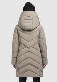Padded, hooded coat in light beige with chevron pattern. Features a high collar and a logo patch on the lower left side.