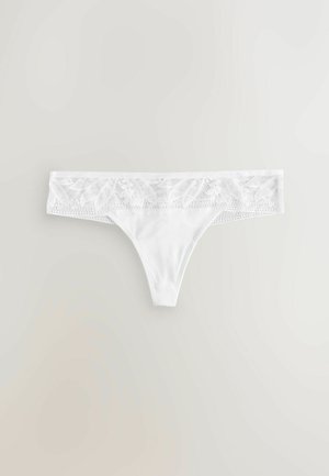 Biele tanga s širokým čipkovaným pásom s kvetinovým vzorom a hladkým, pevným materiálom na tele. Nastaviteľný a bezšvový dizajn.